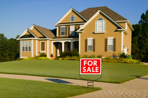 Exterior of home with 'for sale' sign in front yard