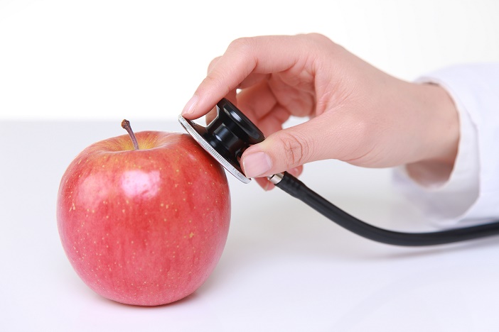 Medical doctor stethoscope examine an apple